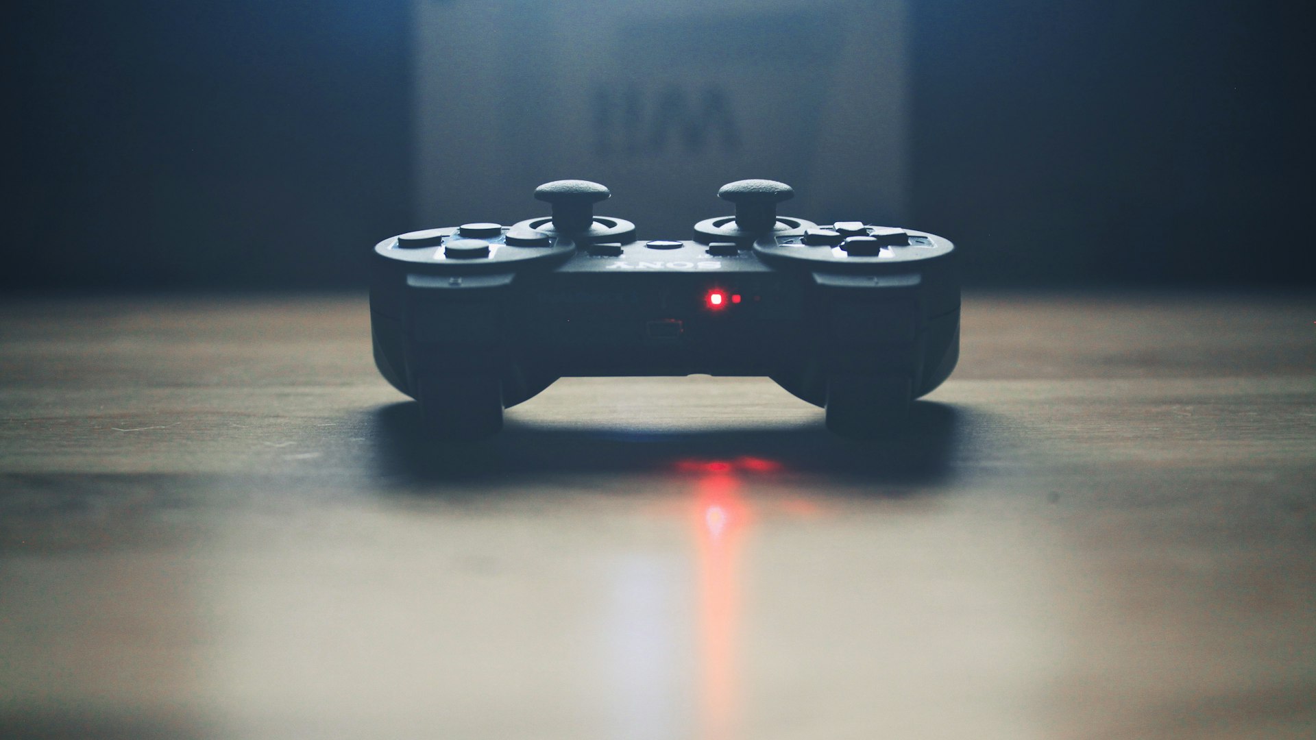 Gamers mid-match at a dim lit setup